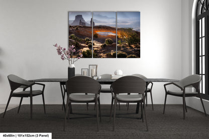 a dining room table with four chairs and a painting on the wall