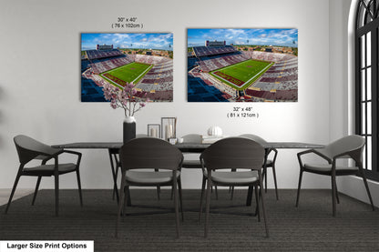 a dining room table with chairs and two pictures of a stadium