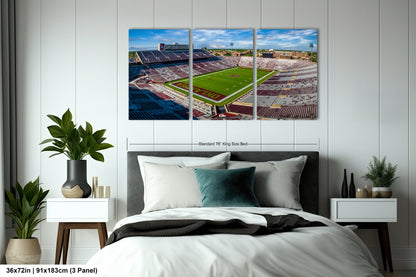 a bed room with a neatly made bed and two pictures on the wall