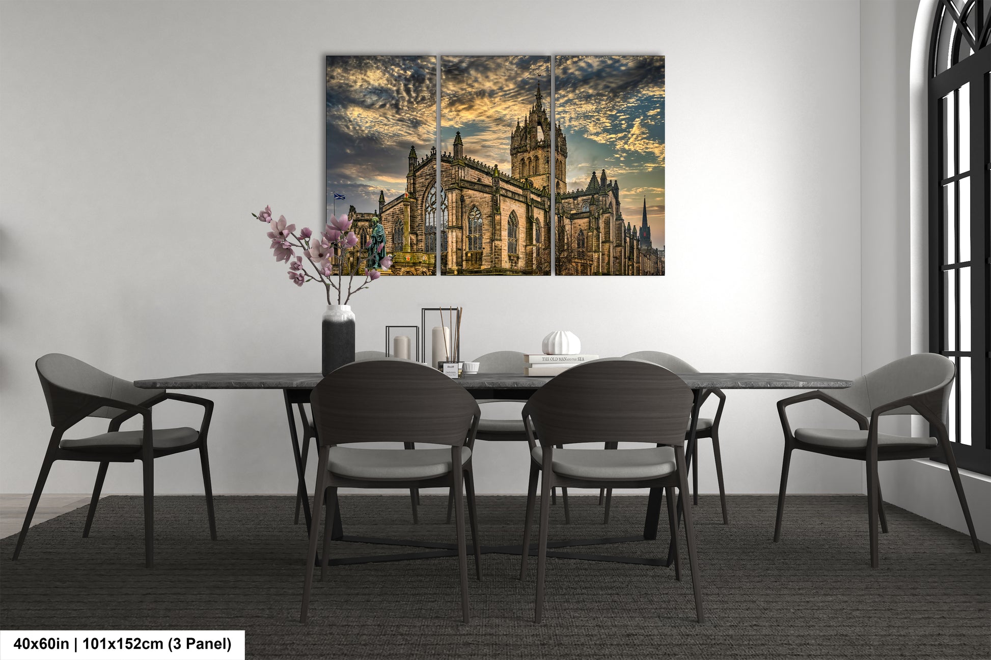 a dining room table with chairs and a painting on the wall