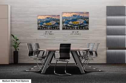 a dining room table with chairs and a picture of a stadium