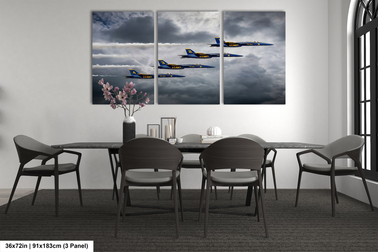 a dining room table with chairs and a painting on the wall