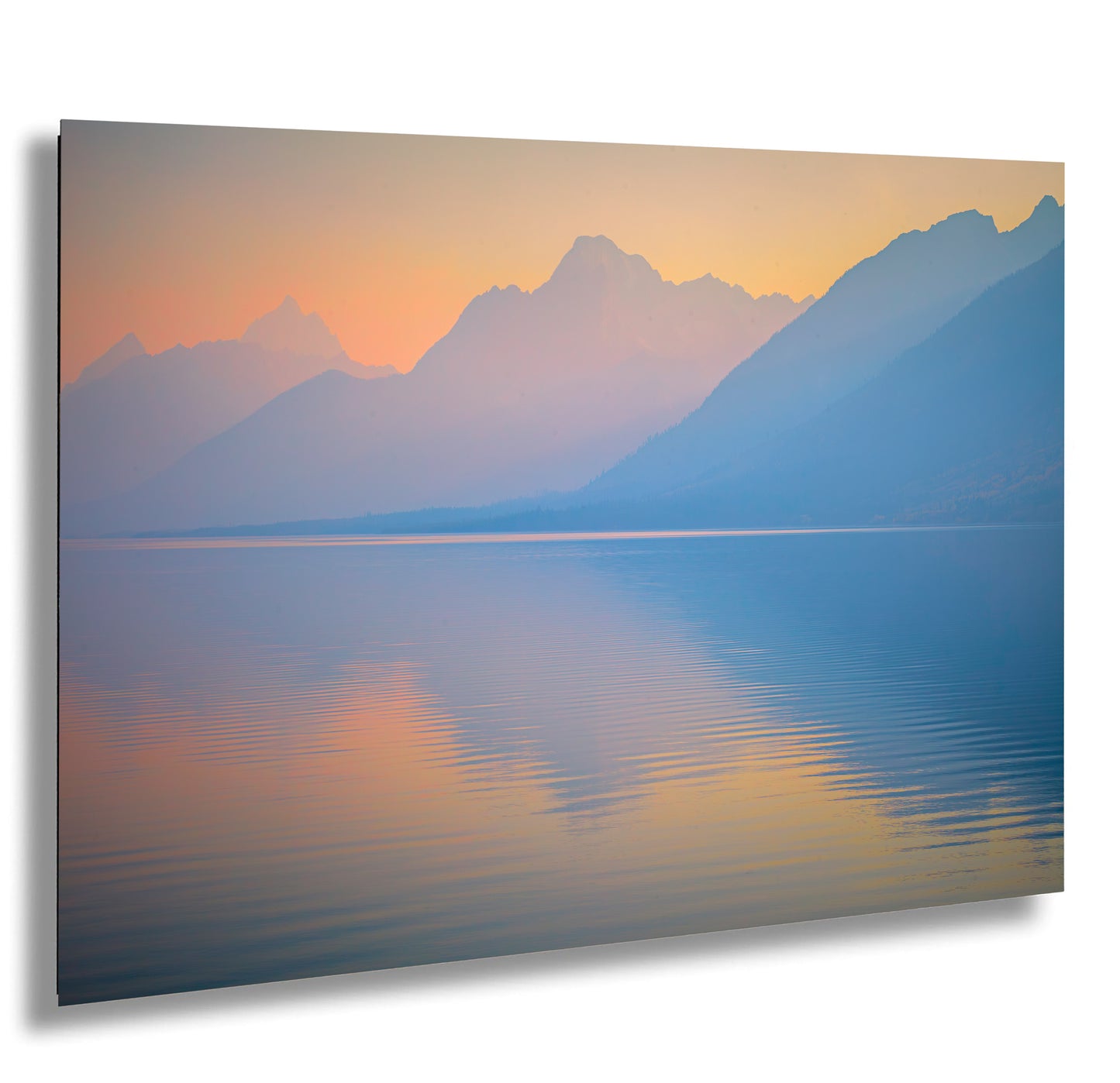 a large body of water with mountains in the background