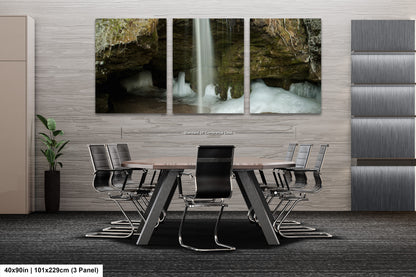 a dining room table with chairs and a waterfall in the background