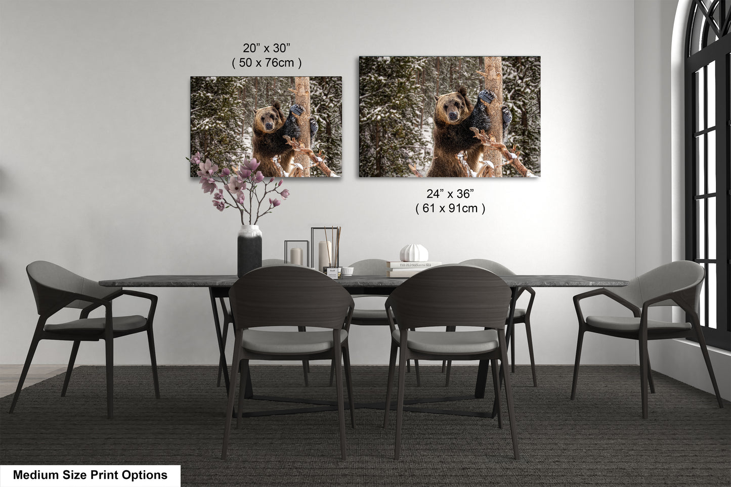 a dining room table with four chairs and a vase with flowers