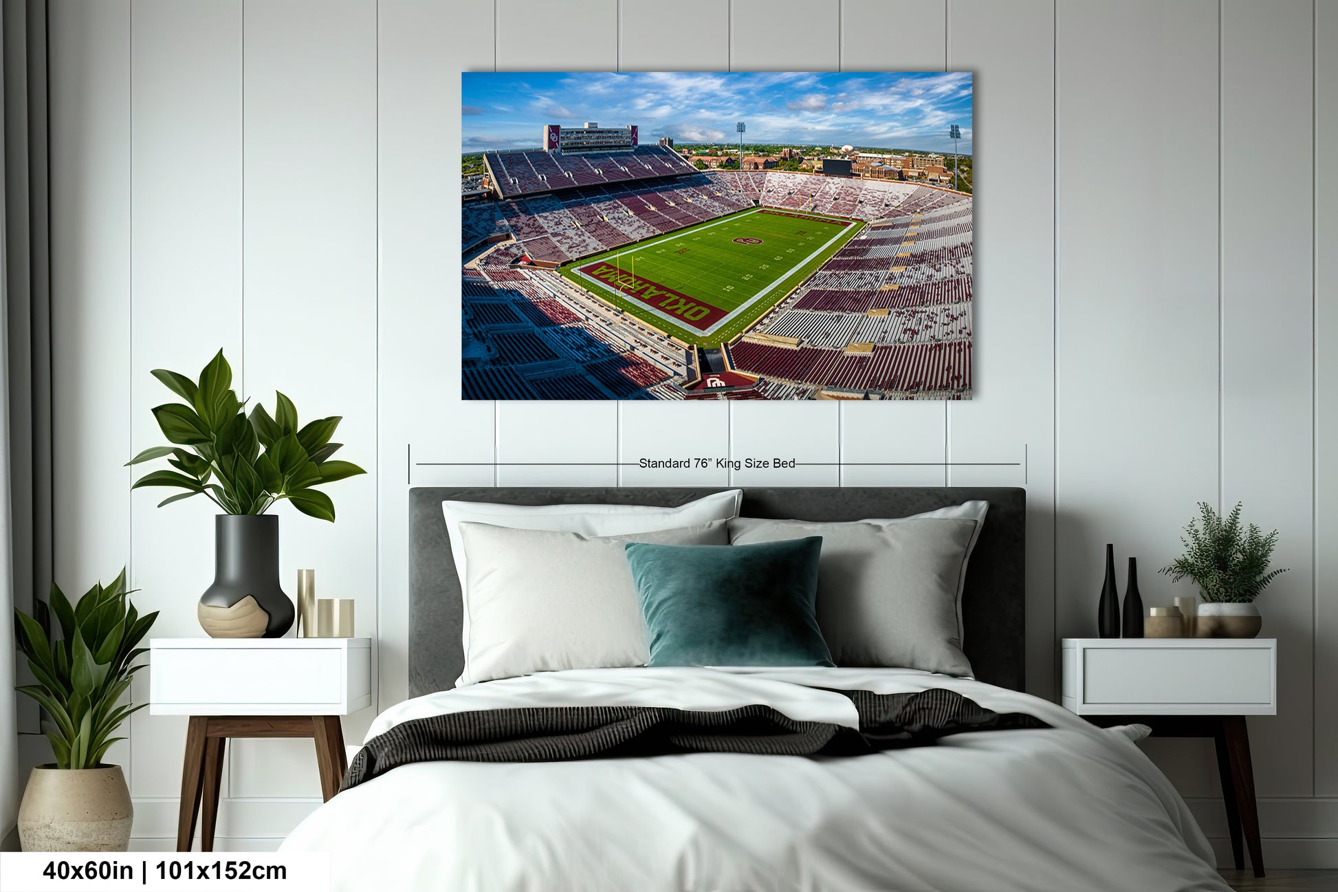 a bedroom with a large bed and a painting on the wall