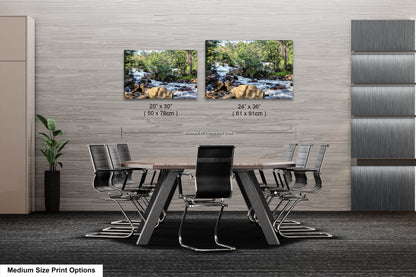 a dining room table with chairs and two pictures on the wall