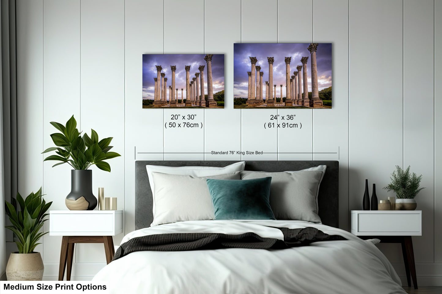 a bed with a white comforter and two pictures on the wall