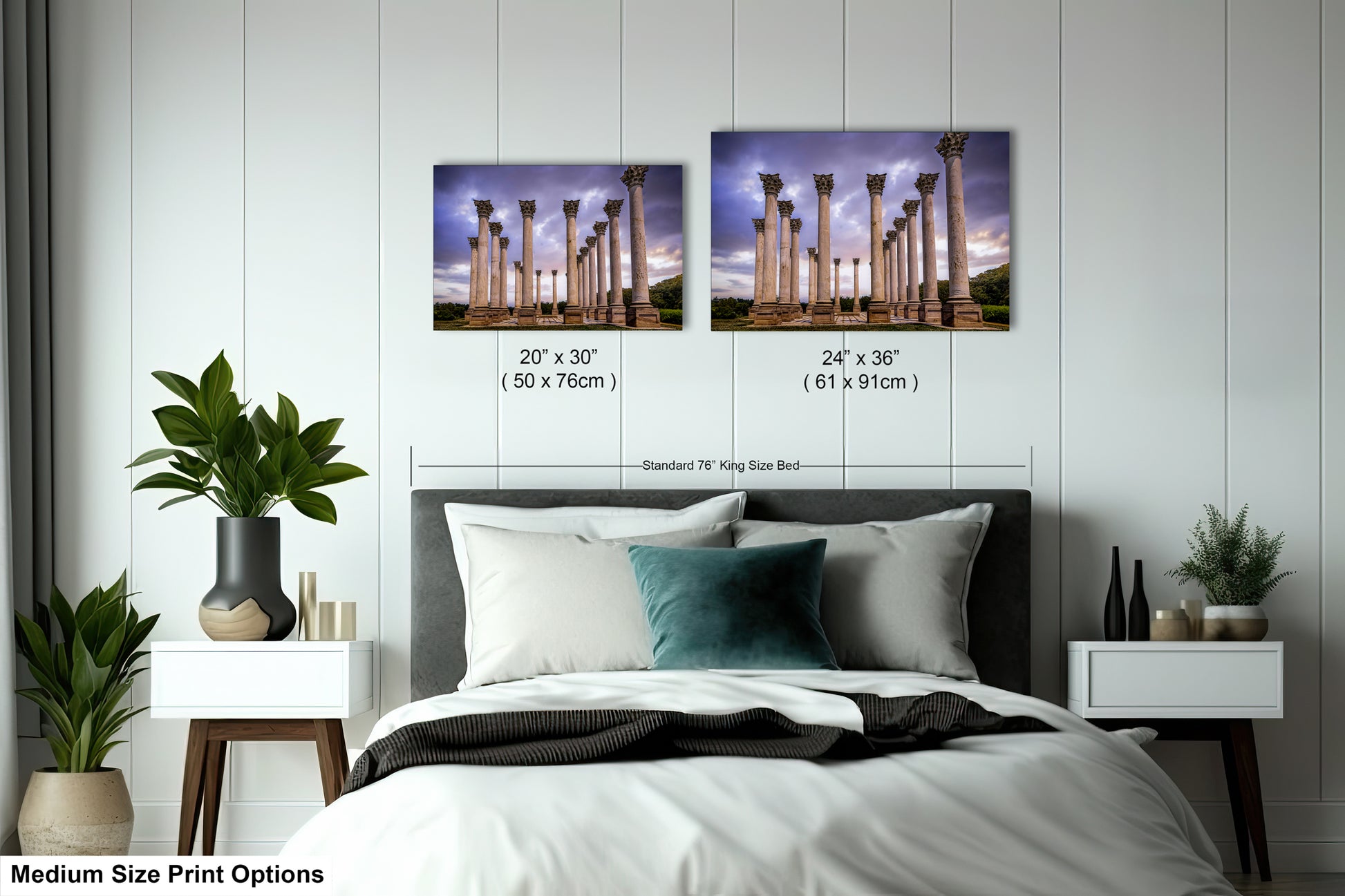 a bed with a white comforter and two pictures on the wall