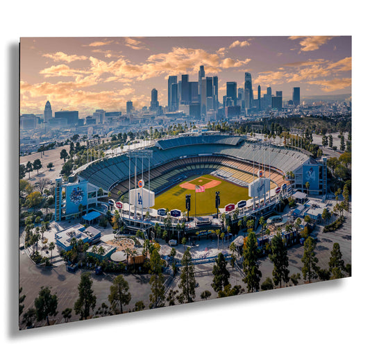 an aerial view of a baseball stadium with a city in the background