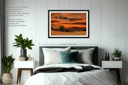 a bedroom with a large bed and a painting on the wall