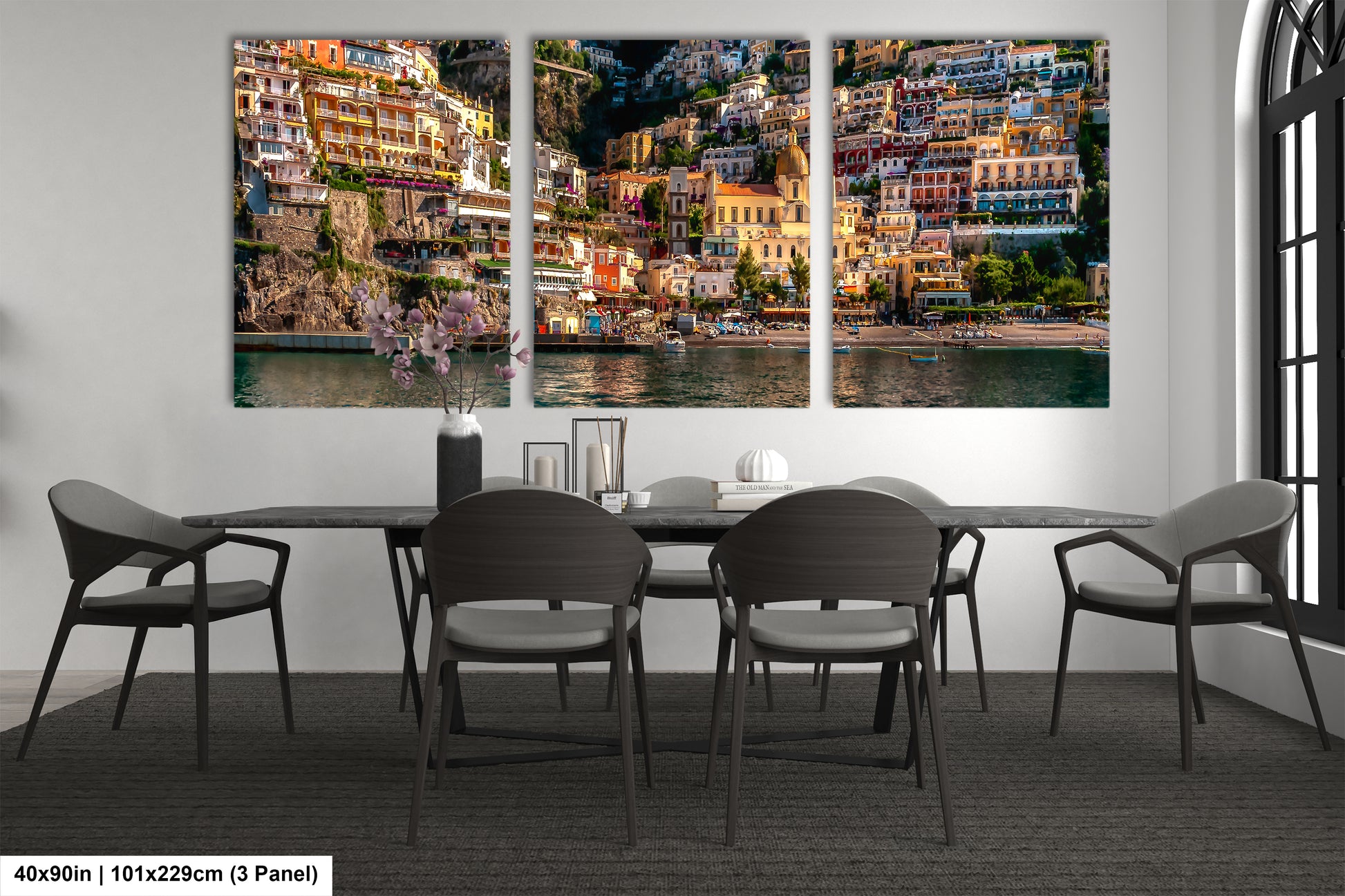 a dining room table with chairs and a painting on the wall