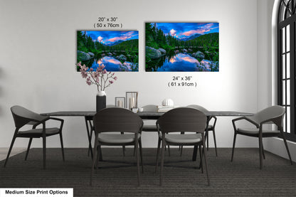 a dining table with four chairs and a vase of flowers