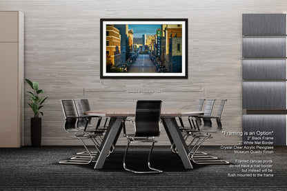 a dining room table with chairs and a picture hanging on the wall