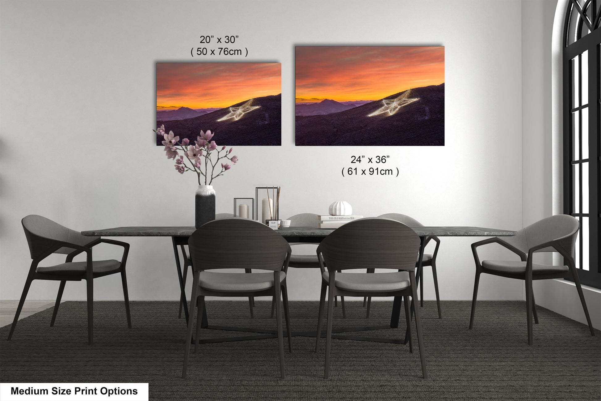 a dining table with four chairs and a vase with flowers