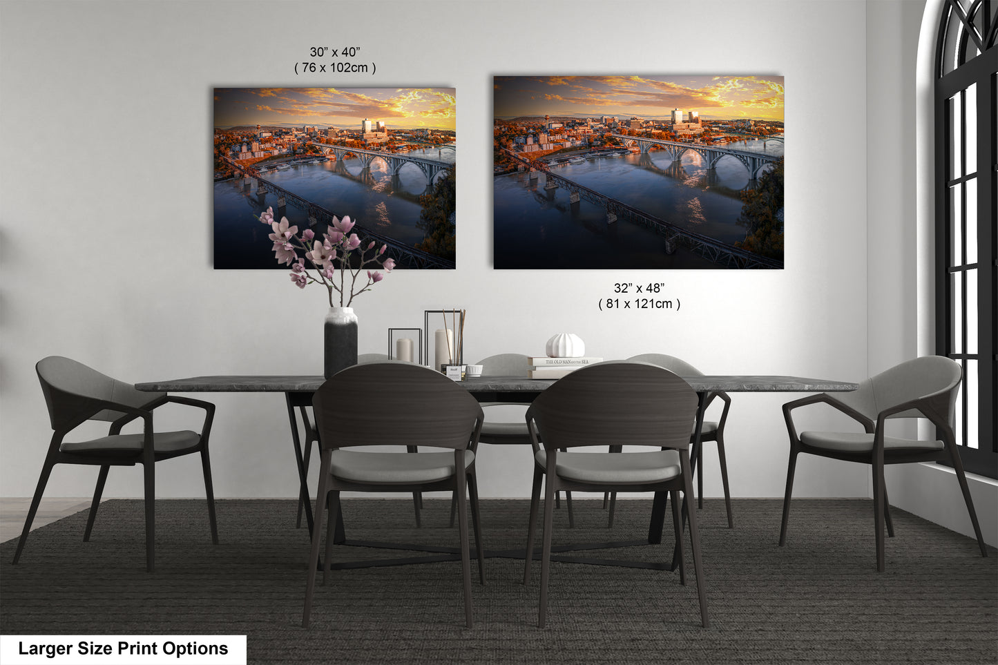 a dining room table with four chairs and a vase of flowers