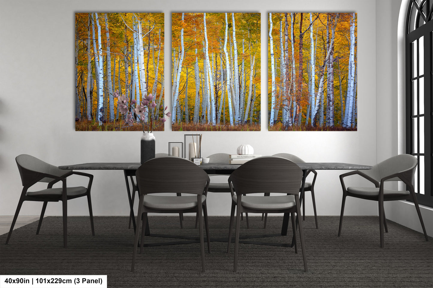 a dining room table with four chairs and a painting on the wall