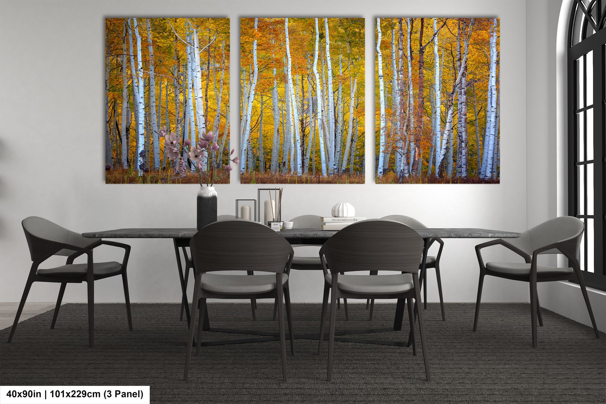 a dining room table with four chairs and a painting on the wall