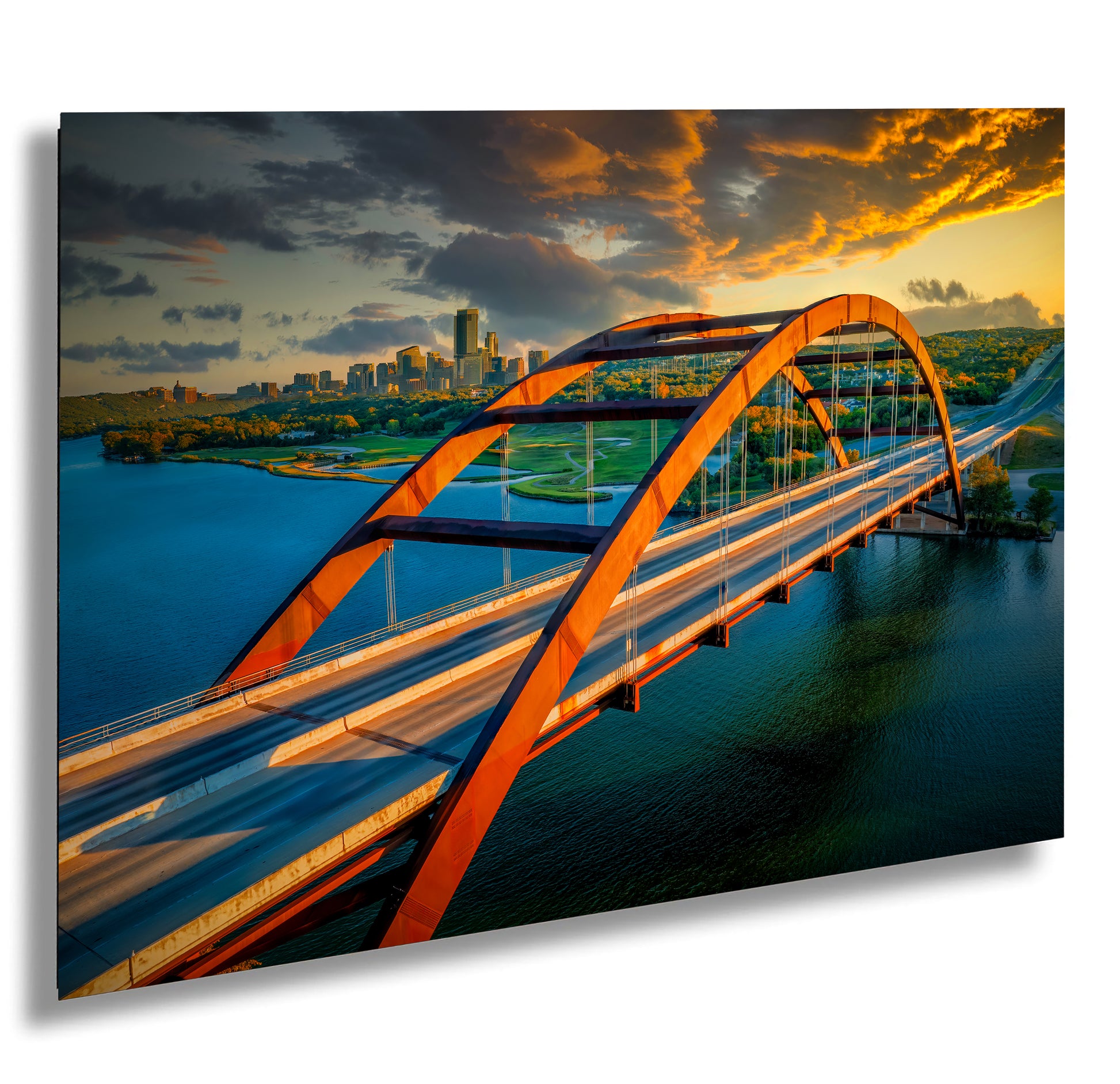 a bridge over a body of water with a city in the background