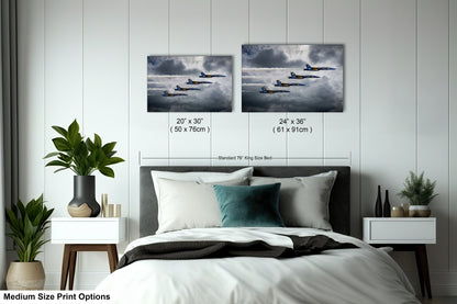 a bed with two pictures of planes flying in the sky