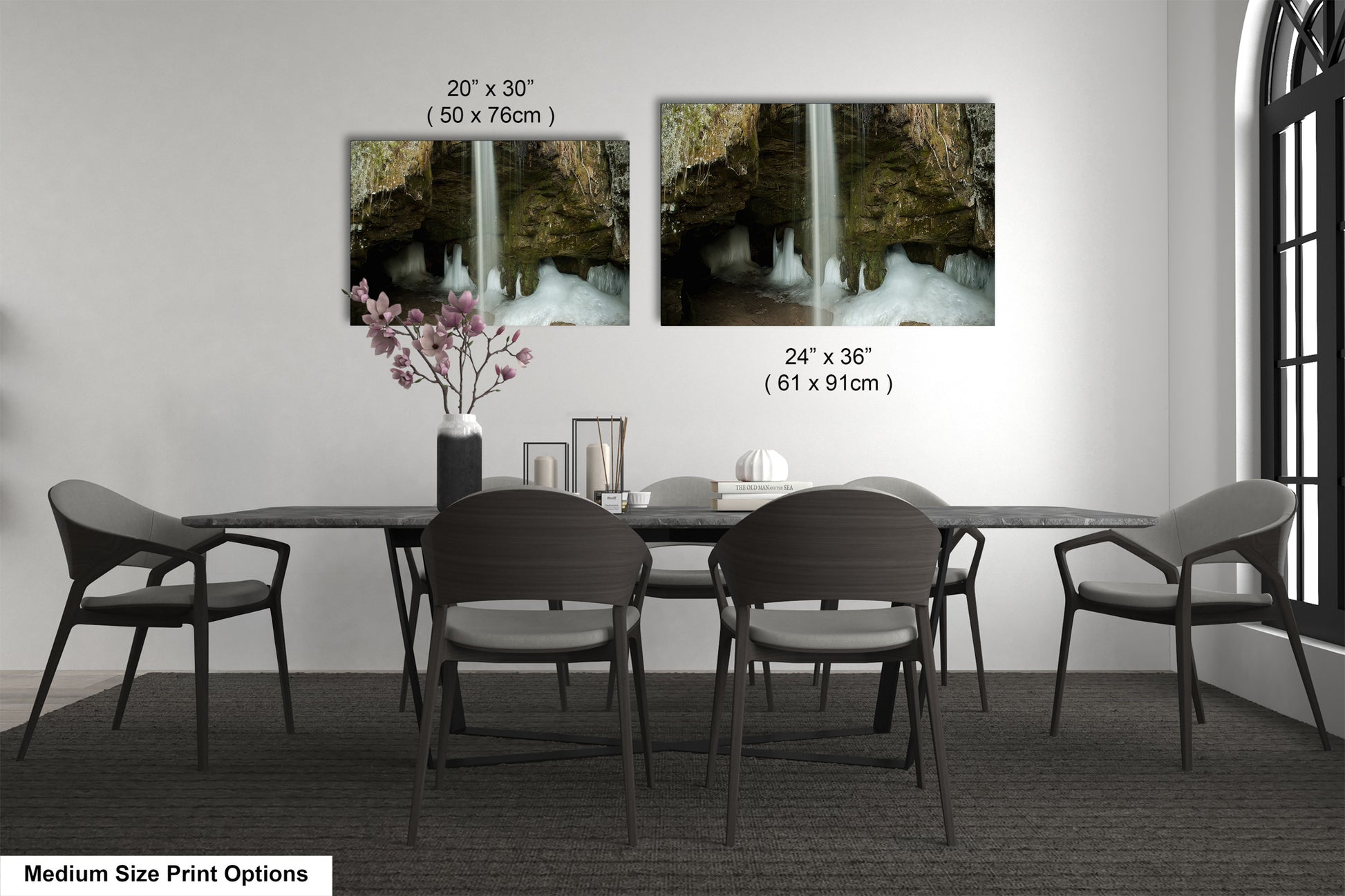 a dining room table with four chairs and a vase with flowers