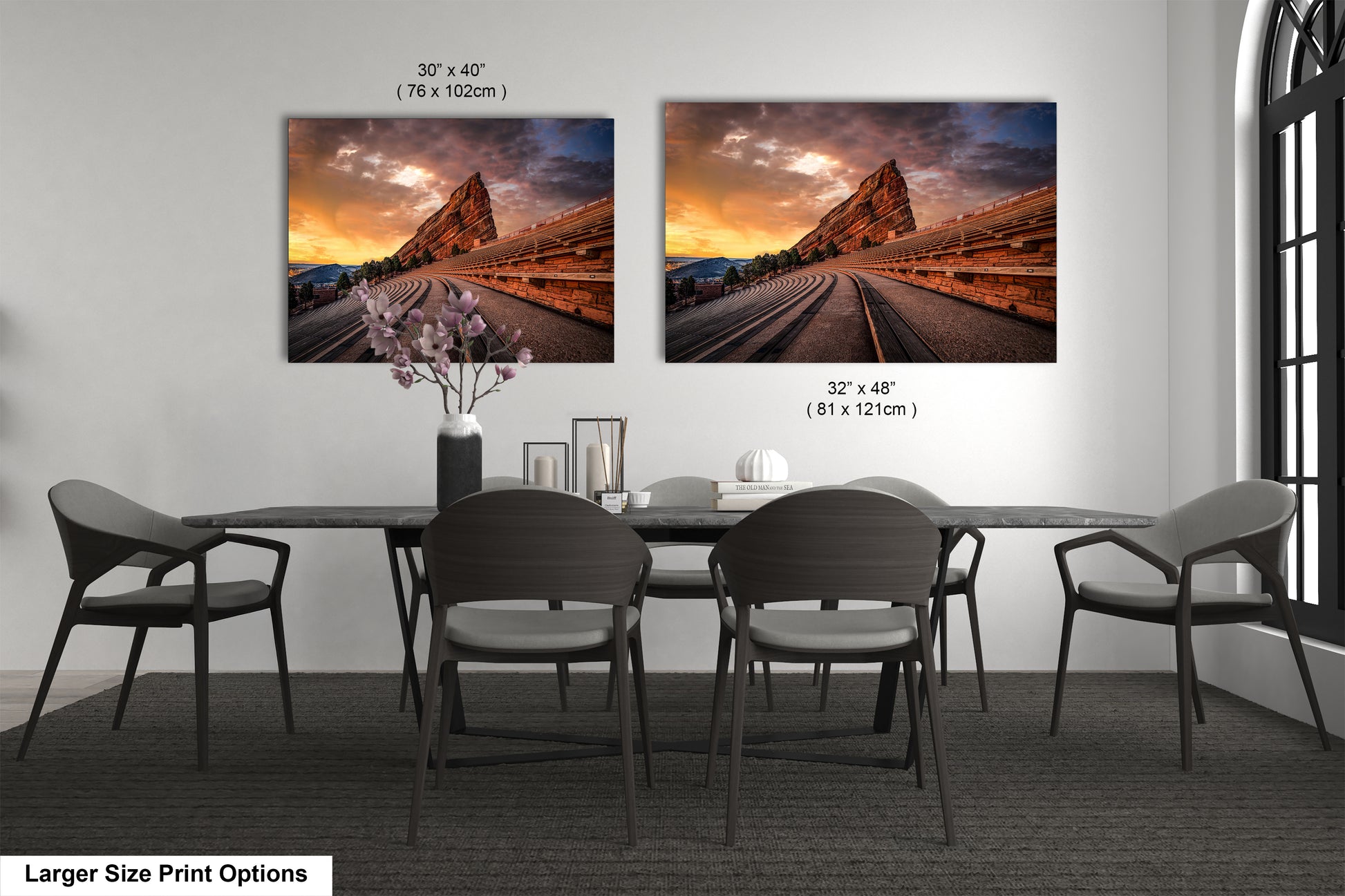 a dining room table with four chairs and two pictures on the wall