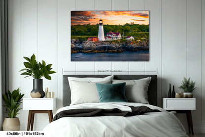 a painting of a lighthouse on a wall above a bed