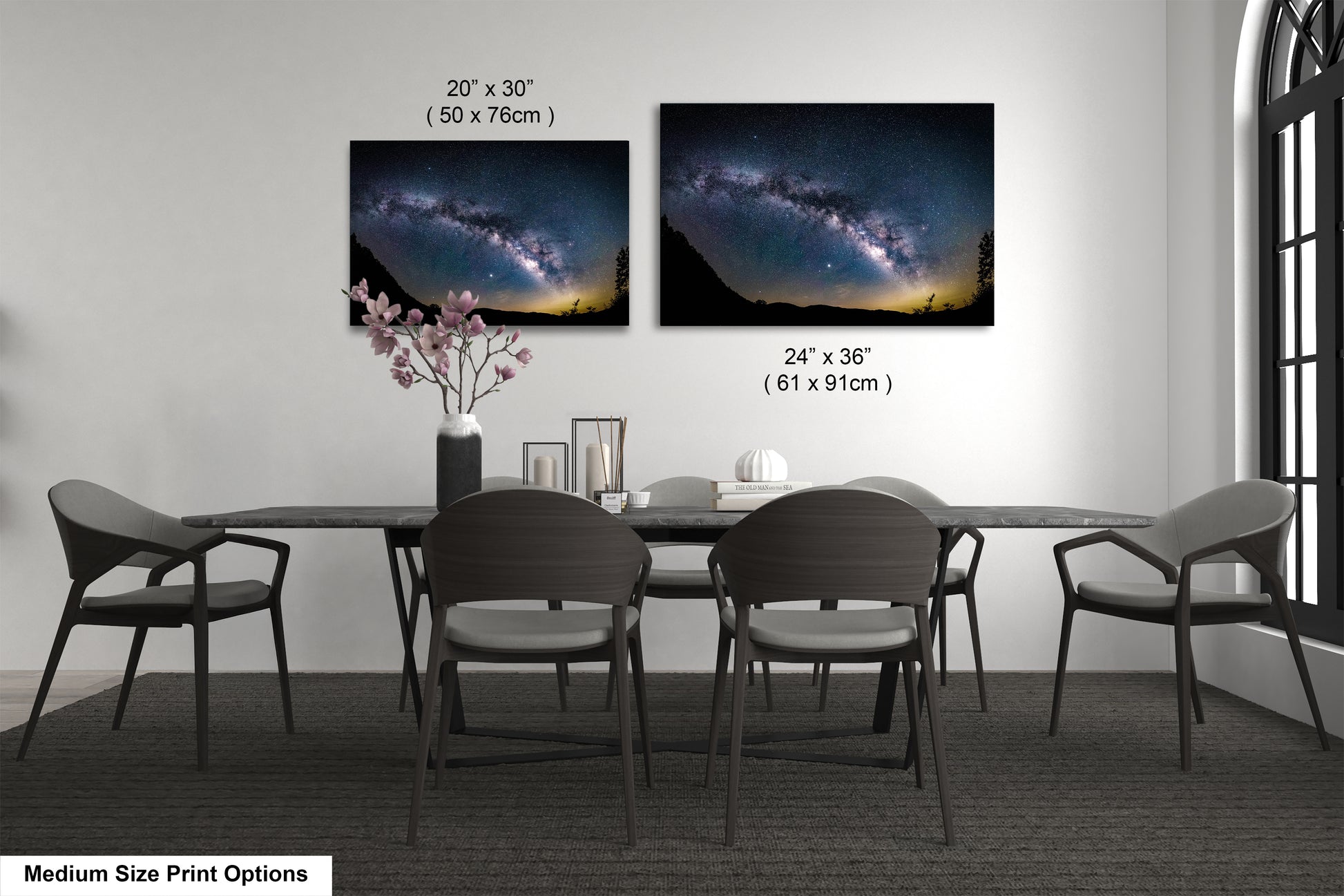 a dining room table with four chairs and a vase of flowers