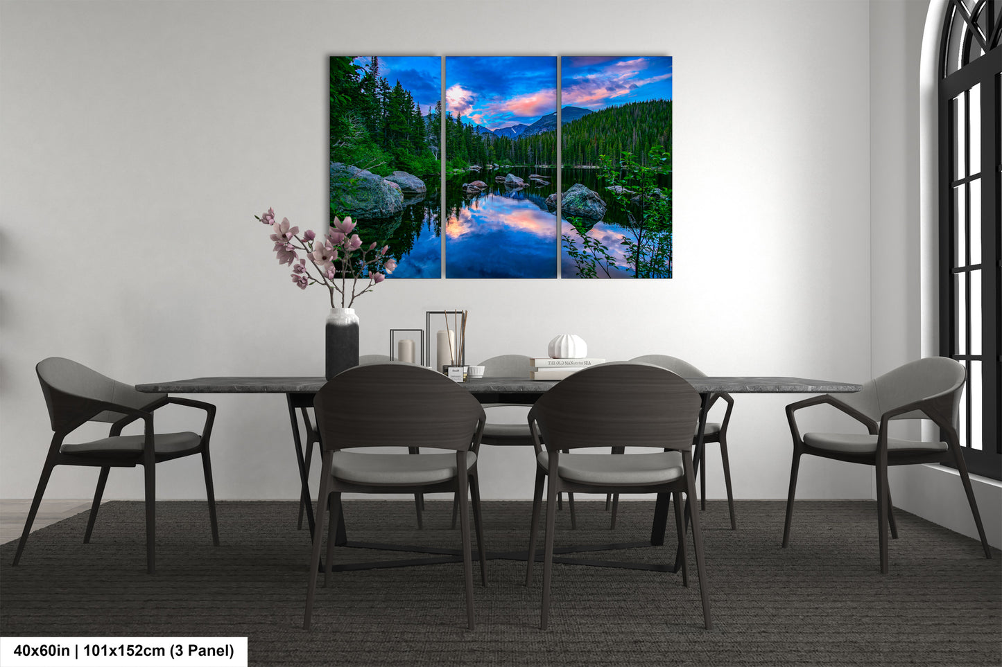 a dining room table with chairs and a painting on the wall