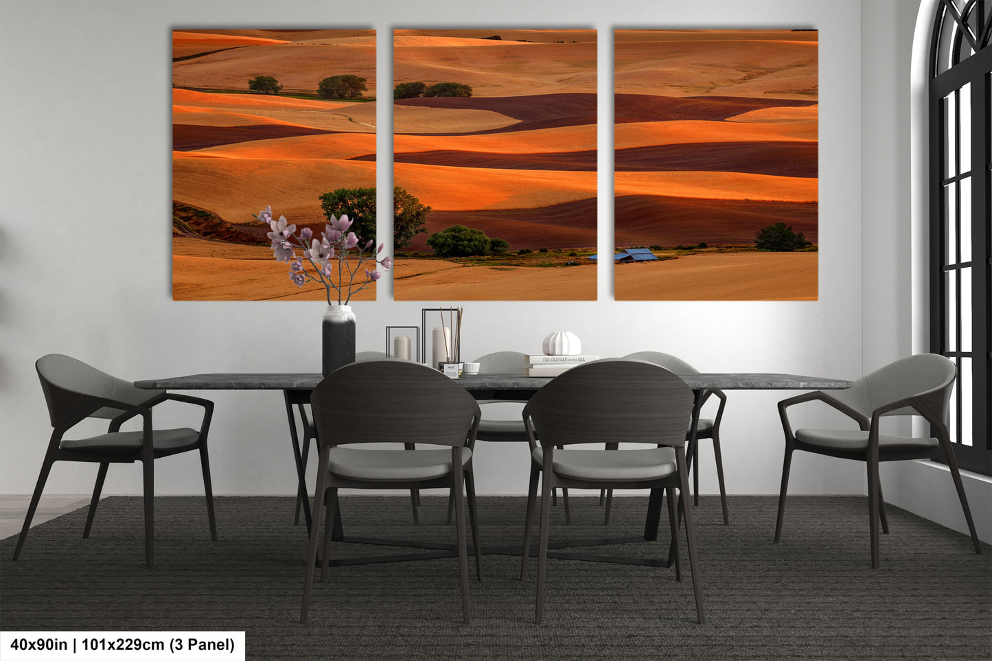 a dining room table with chairs and a painting on the wall