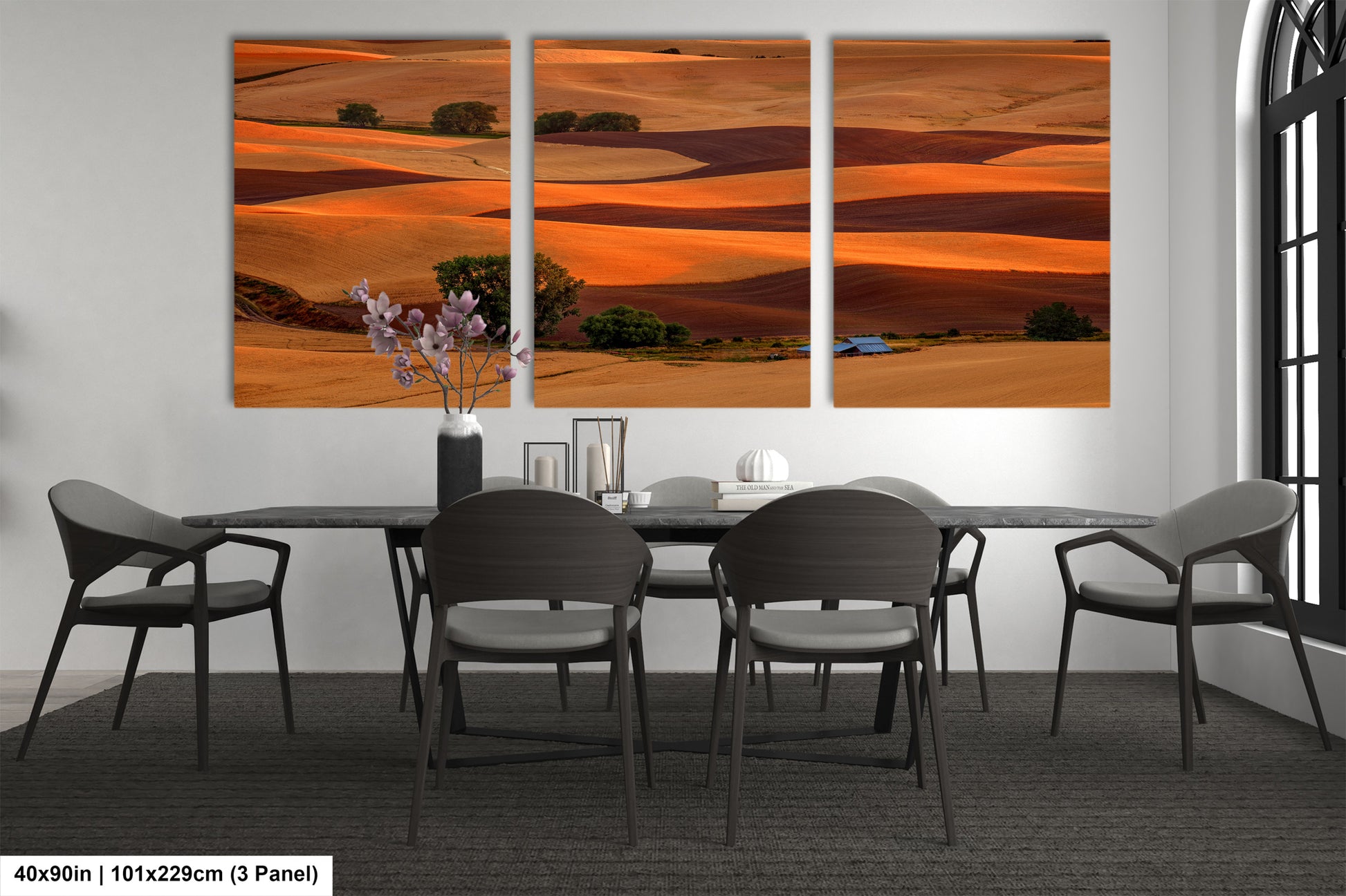 a dining room table with chairs and a painting on the wall