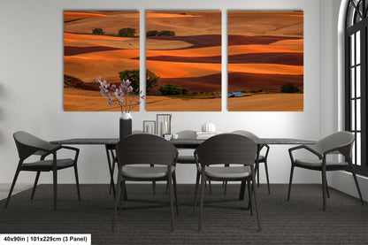 a dining room table with chairs and a painting on the wall