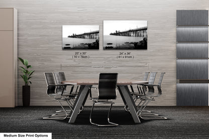 a dining room table with chairs and a picture of a bridge