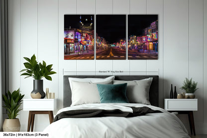 a bed room with a neatly made bed and two paintings on the wall