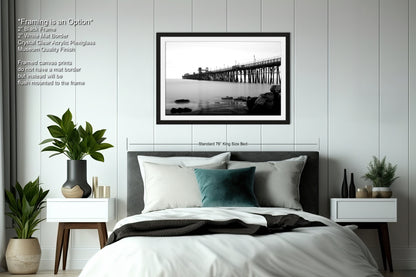 a bedroom with a bed and a picture hanging on the wall