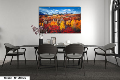a dining room table with chairs and a painting on the wall