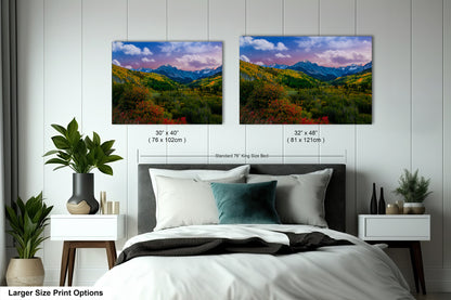 a bedroom with a bed and two pictures on the wall
