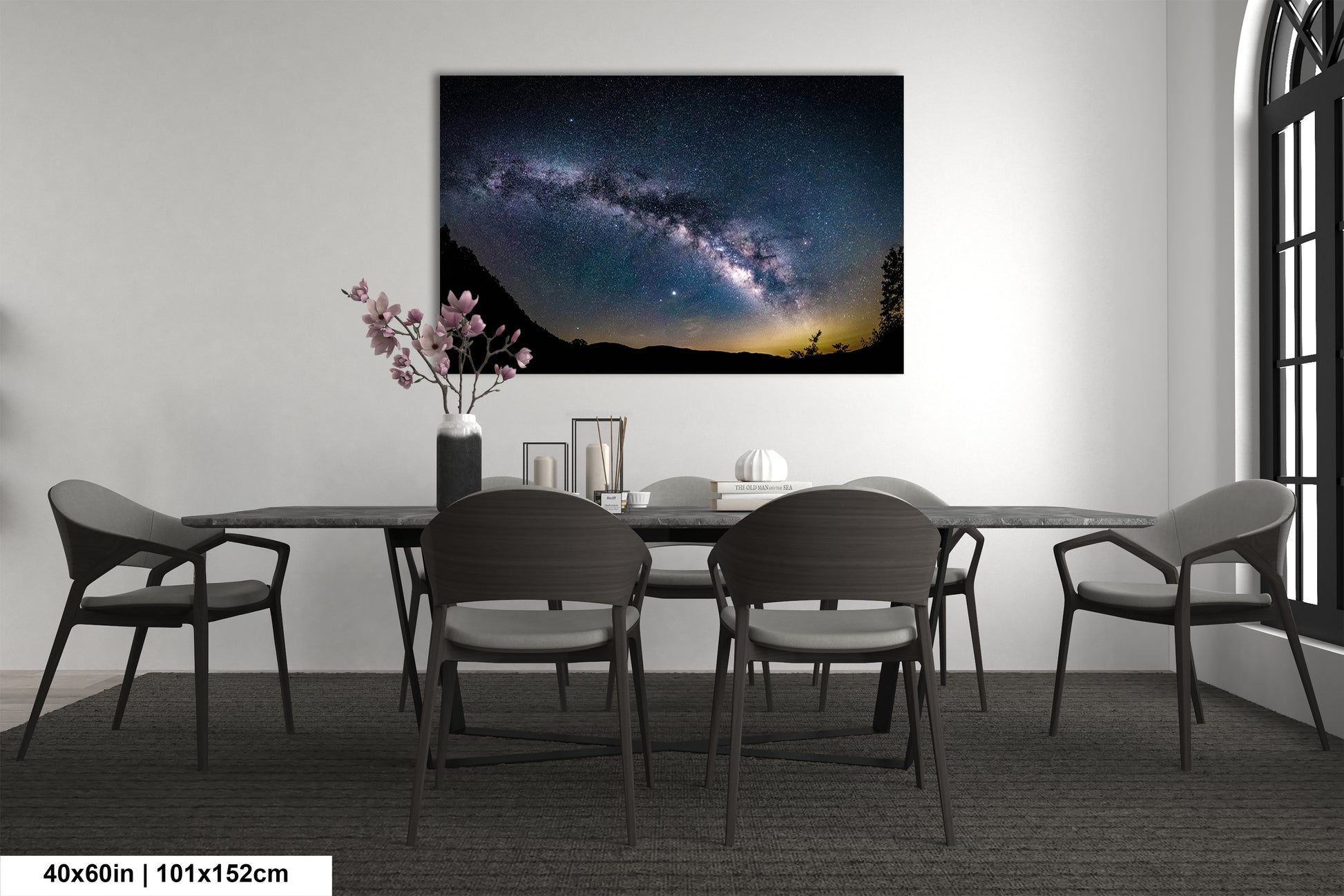 a dining room table with chairs and a painting on the wall