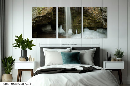 a bedroom with a bed and two paintings on the wall
