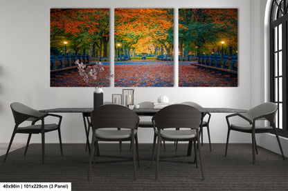 a dining room table with four chairs and a painting on the wall