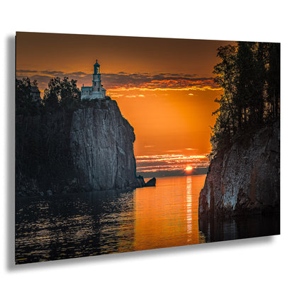 a lighthouse sitting on top of a cliff next to a body of water