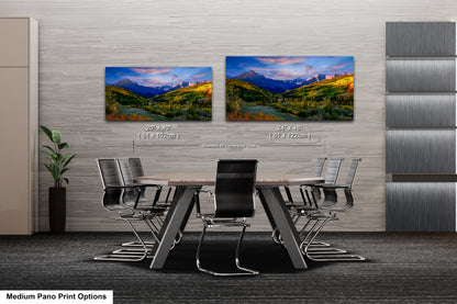 a dining room table with chairs and a painting on the wall