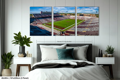 a bed room with a neatly made bed and two pictures on the wall