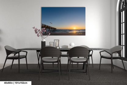 a room with a table and chairs and a painting on the wall