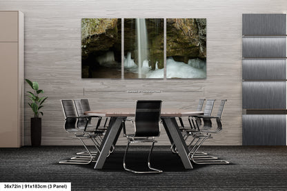 a dining room table with chairs and a waterfall in the background