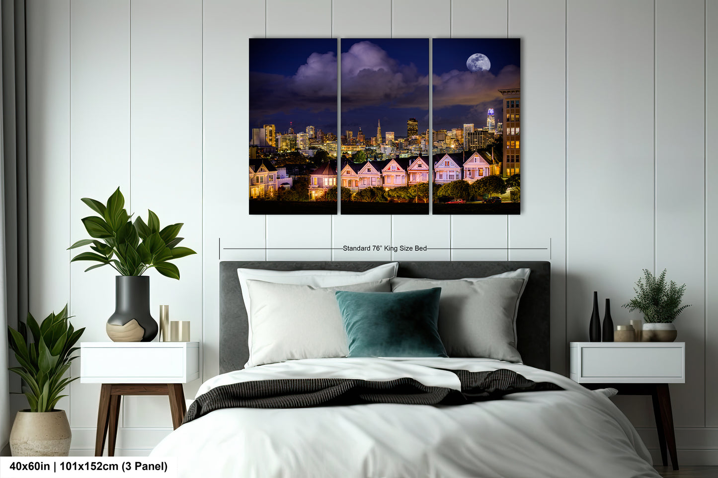 a bedroom with a bed and a night view of a city