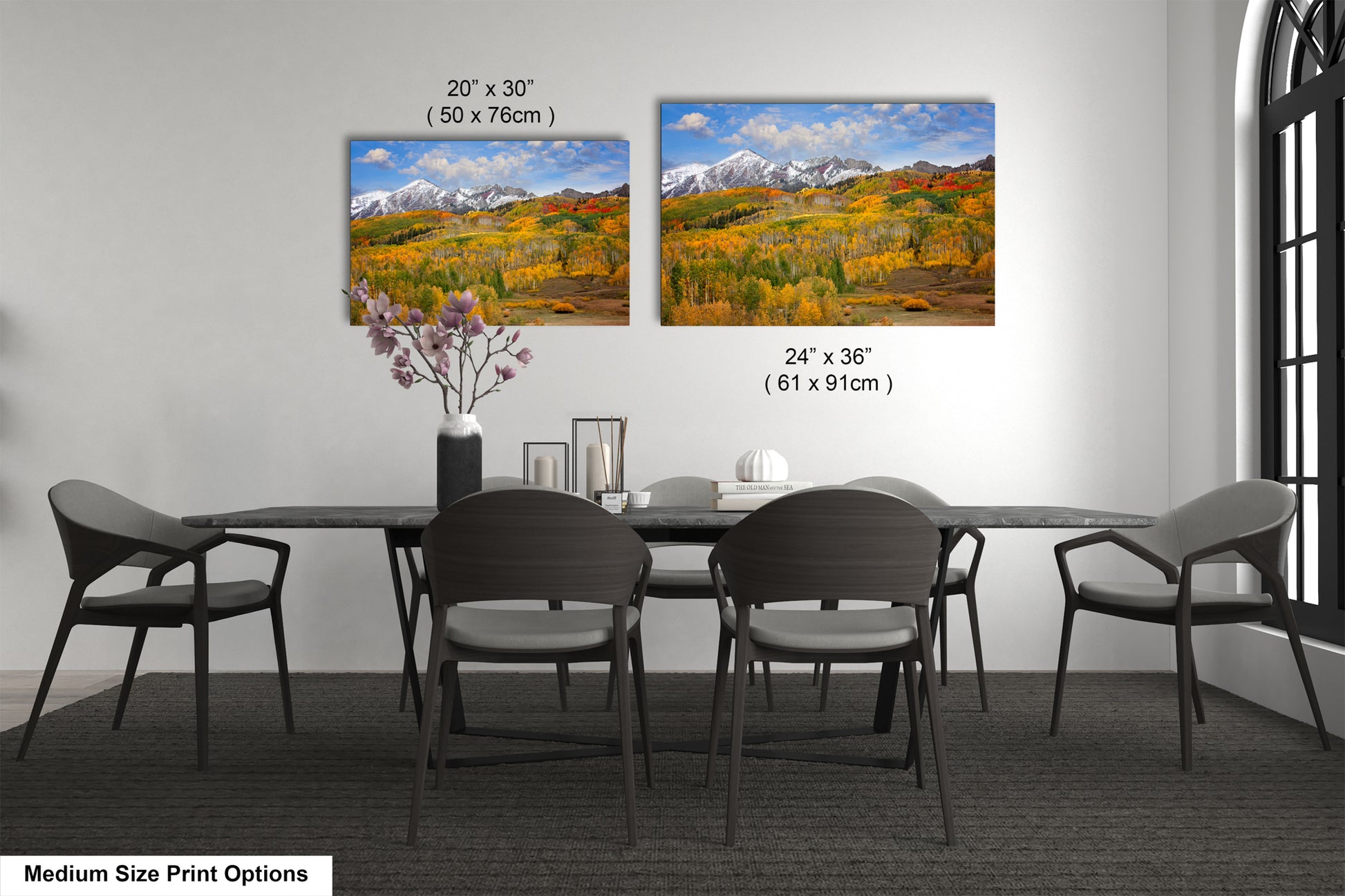 a dining room table with four chairs and a vase of flowers
