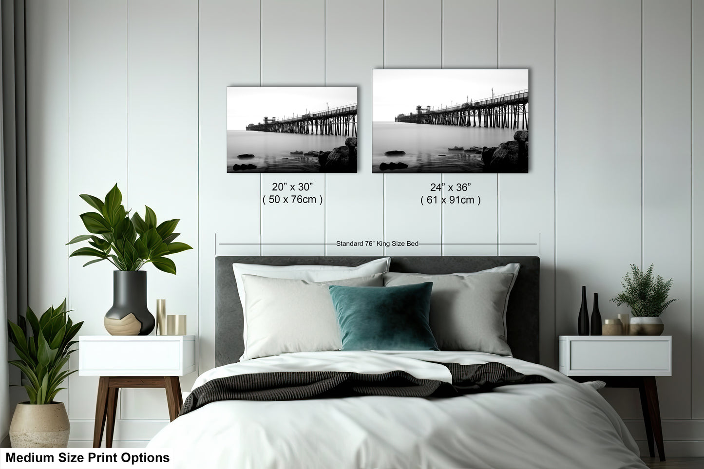 a bedroom with a bed and two pictures on the wall