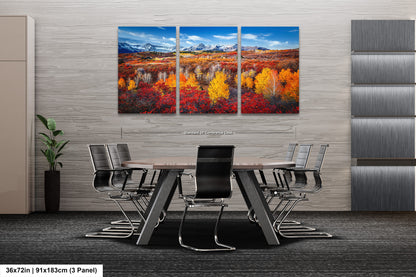 a dining room table with chairs and a painting on the wall