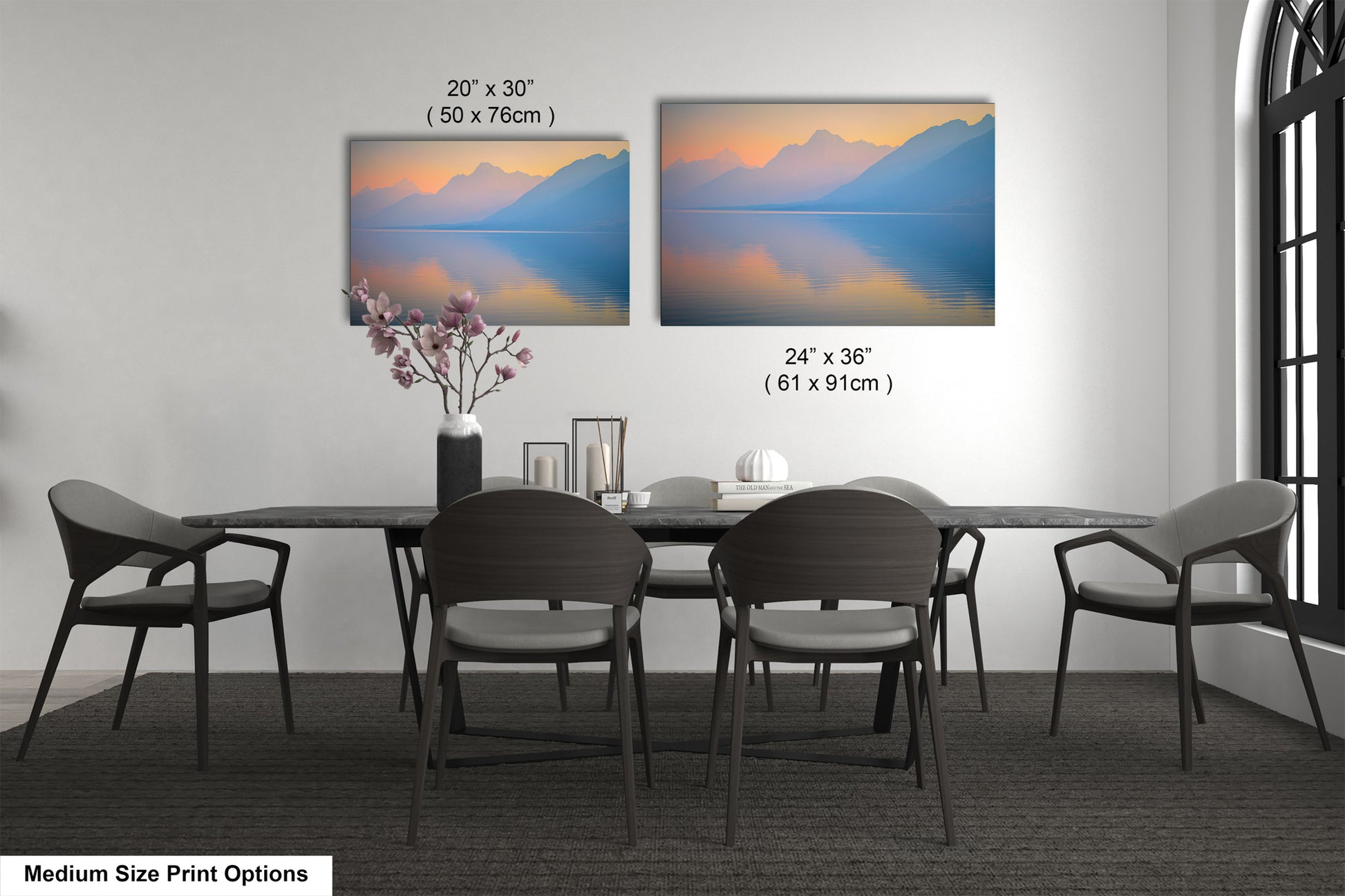 a dining table with four chairs and a vase with flowers